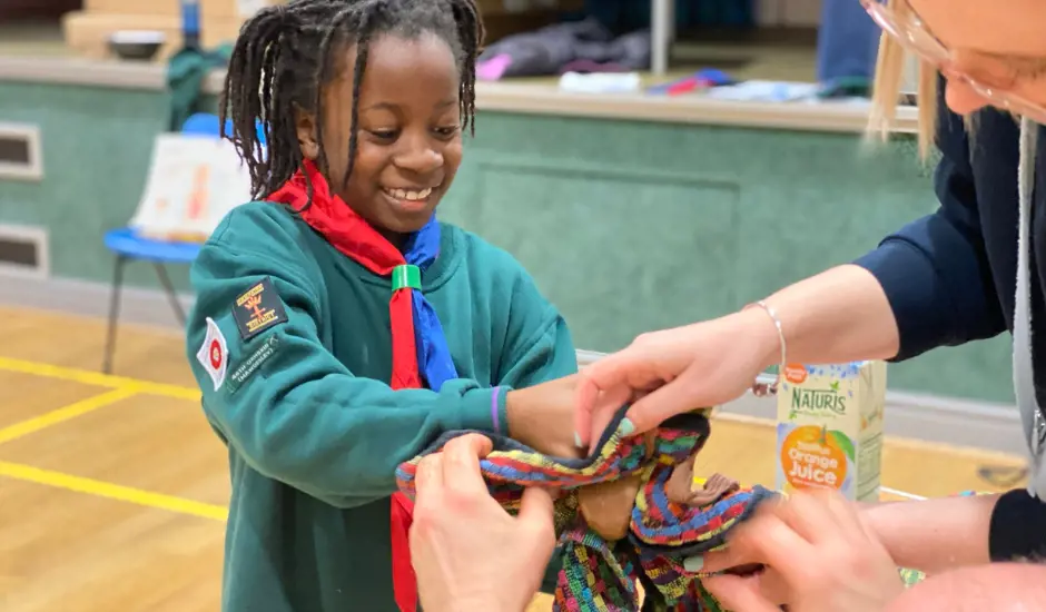 young girl at scouts taking part in an experiment 