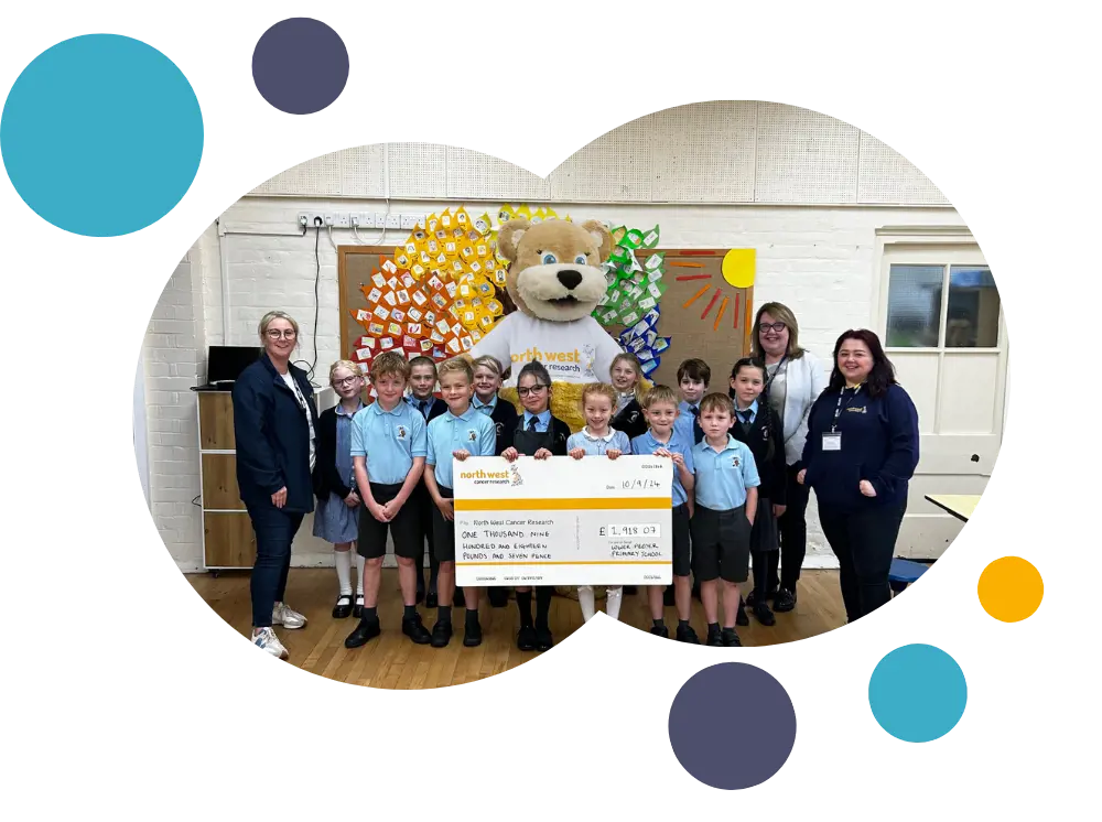 classmates presenting a cheque to nwcr staff, along with hope bear mascot 