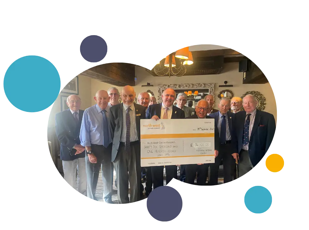 Heswall holding a cheque 